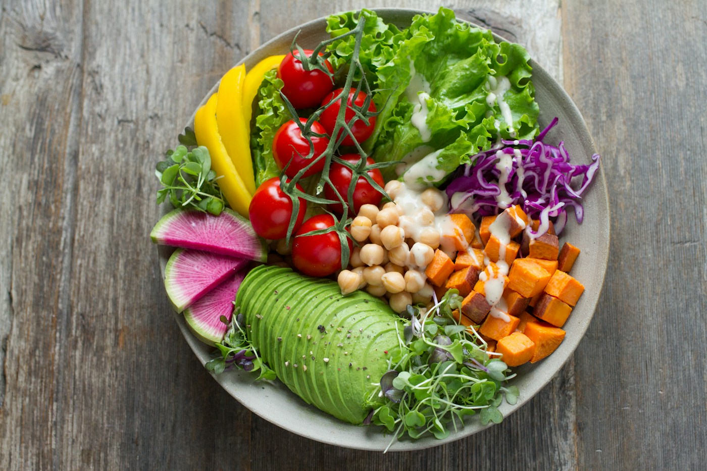 A colorful bowl of vegetables, chickpeas and avocado